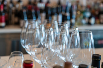 Empty glasses for wine near a bar rack, close up
