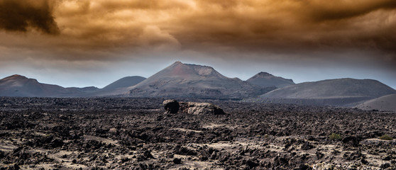 lanzarote volcano with dramatic storm clouds.