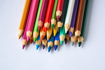 Pile of colored pencils on a white background