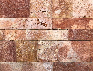 Pattern of decorative red stone wall background.Stone wall texture. random size stone wall.Background of stone wall.