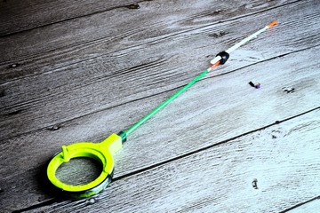 Ice fishing tackle on the grey wooden table