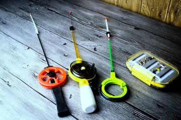 Ice fishing tackle on the grey wooden table