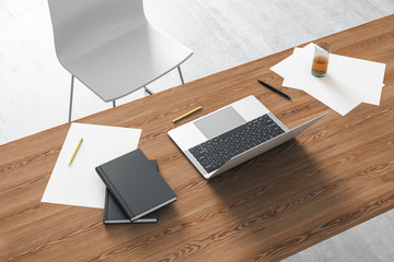 Top view of a modern workplace with a wooden desk and a laptop. 3D Rendering