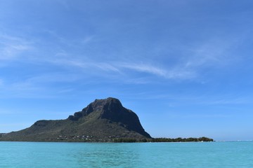 Picture of a beautiful island surrounded by tropical blue waters. Adventure, seascape, vacations backgrounds.