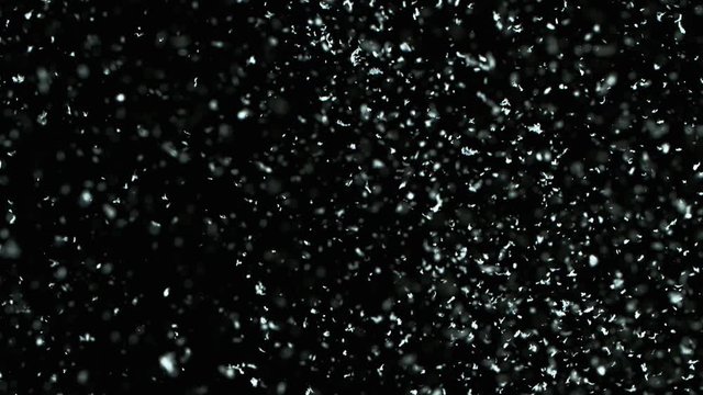 Winter Snow falling on black background in 4K. Slow Motion at 1000 fps.