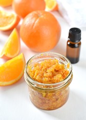 Homemade orange peel body scrub with essential oil, close up view.
