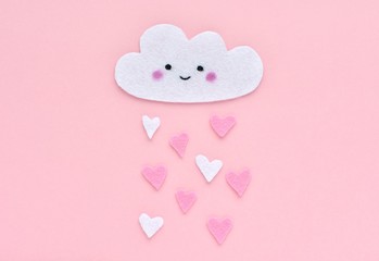 Valentines day concept, cute smiling face cloud made and hearts made from felt fabric, kawaii style, oink background.
