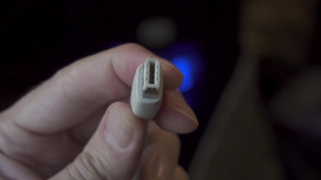 Examining a White IEEE 1394 FireWire 6 Pin Cable