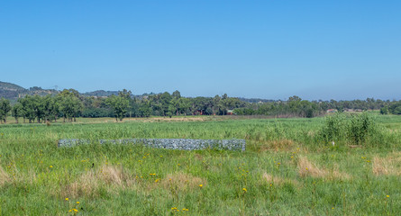 A gabion wall constructed to control flooding in a low lying area image with copy space in horizontal format