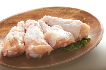 Chicken drumsticks on wooden plate with copy space