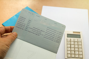 Obraz premium passbooks saving account, calculator with note on wood background