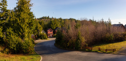 Sunny Sunrise in Residential Neighborhood of a small town, Ucluelet, during Autumn Season. Located in Vancouver Island, British Columbia, Canada. Aerial Panoramic View