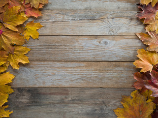 Naklejka na ściany i meble autumn colorful leaves on wooden table