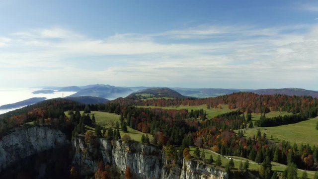 Aerial footage of flight forward over autumn colored mountain landscape at Grenchenberg in Switzerland