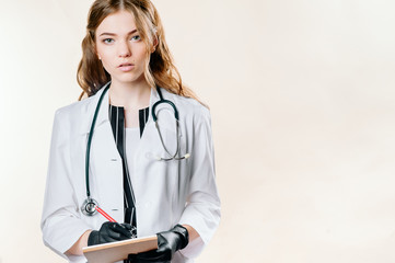 Girl doctor blond young light background studio day beautiful one positive tablet looking smiling concept of remote customer care online patients.