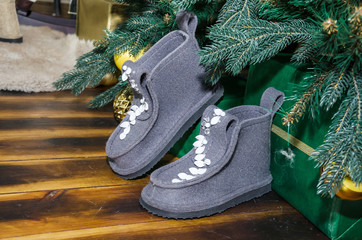 gray felt boots under the christmas tree.