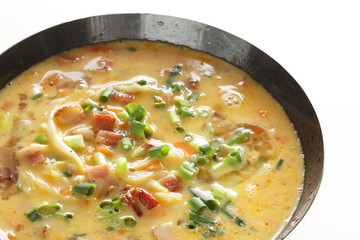 Chopped cabbage, carrot, spring onion, bacon in egg wash