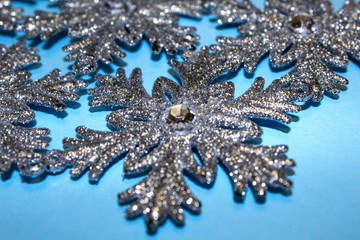 silver sparkling snowflakes on winter blue classic background close up