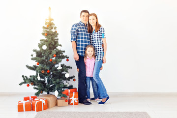 Holidays and festive concept - Happy family portrait with Christmas tree