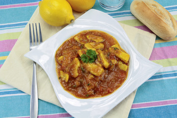 squid in tomato sauce on a plate