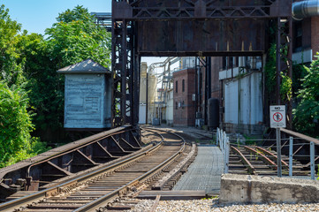 Fototapeta na wymiar Railroad Tracks beside Warehouse