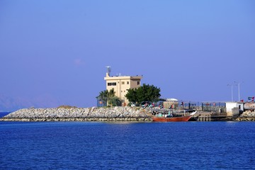 view of stone pier in Dibba by mountain in fog