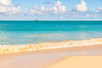 Idyllic tropical beach at Antigua island in Caribbean with white sand, turquoise ocean water and...