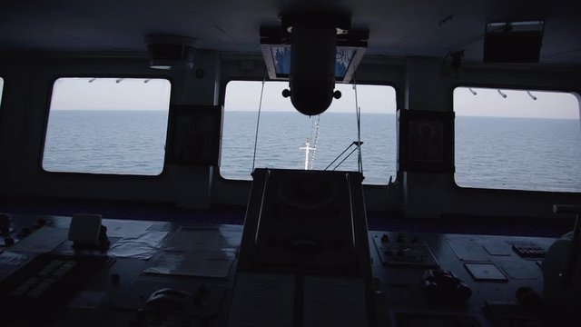 Beautiful view through window of ship moving along black sea on summer day. Amazing seascape with blue waters and interior of cruise liner with control panel during maritime. Concept: travel, nautical