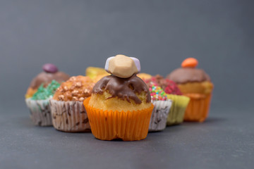 assorted fresh tasty muffins on dark background