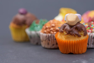 assorted fresh tasty muffins on dark background