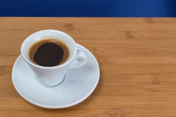 black coffee in a coffee cup from above isolated on wooden background. with clipping path.