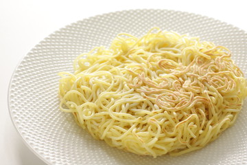 Chinese food, pan fried ramen noodles on white dish