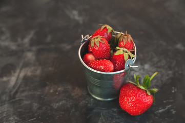 Fresh strawberries closeup. Ripe strawberries on a dark background and copy space.