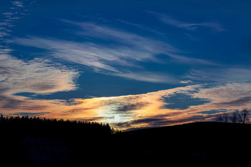 Colorful sunset in the winter forest. Beautiful winter landscape in the mountains. Sunrise.