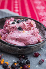 Homemade banana ice cream with black berries, blackcurrant in bowl. Vegan, vegetarian healthy food. 