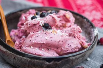 Homemade banana ice cream with black berries, blackcurrant in bowl. Vegan, vegetarian healthy food. 
