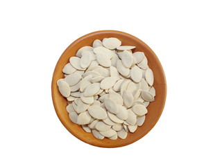 Dry pumpkin seeds  in terracotta cup on white background.