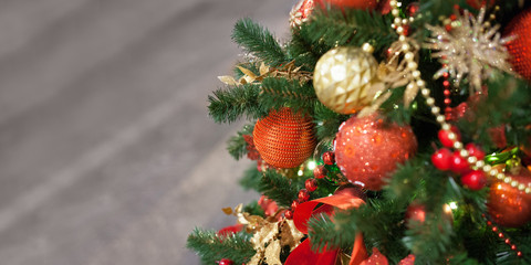 Decorated Christmas tree on blurred, sparkling and fairy background. Сhristmas tree ornament. Pine branch with Christmas balls. Copy space