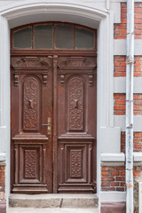 Old decorative dark brown wooden front door