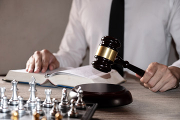 Male lawyer working with lawsuit papers on table in courtroom