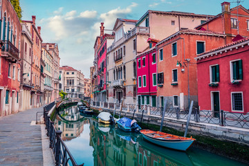 Fototapeta na wymiar Colorful summer cityscape ofVennice with famous water canal and colorful houses. Spectacular morning scene of Italy, Europe. Traveling concept background.