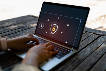 Businessman using a laptop computer with technology cybersecurity and privacy concept. protection and safe data for global network security.