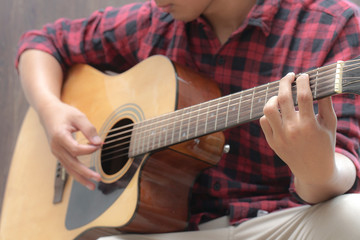 Acoustic Guitar Playing. Men Playing Acoustic Guitar Closeup Photography.