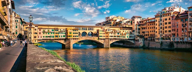Fotobehang Ponte Vecchio Panoramic view of medieval arched river bridge with Roman origins - Ponte Vecchio over Arno river. Colorful summer cityscape of Florence, Italy, Europe. Traveling concept background.