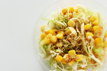 Corn and cabbage with sesame dressing in plastic lunch box