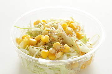 Corn and cabbage with sesame dressing in plastic lunch box