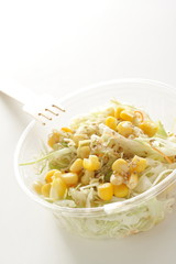 Corn and cabbage with sesame dressing in plastic lunch box