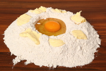 Pile of flour, egg and butter. Making Christmas Gingerbread Cookies