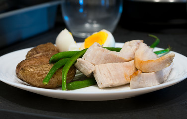 Breakfast with potatoes, chiken, eggs and haricot