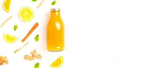 ginger and citrus healthy drink in glass bottle with other ingredients.